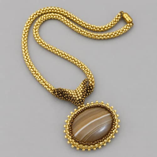 Handmade Jewellery & Stone Library brown banded agate oval pendant on gold seed bead rope